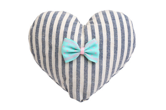 Heart shaped striped pillow with bow isolated on white background.