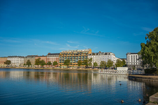 Scenic City Skyline and Architectural Facades Reflected on Lake Water