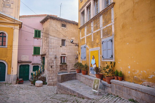 Scenic views of old town Labin in Istria, Croatia. Historic stone houses, tiled roofs, church facade, cozy narrow streets,