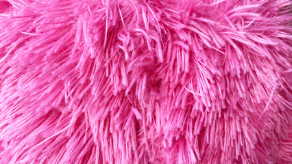 Fototapeta premium Vibrant pink shaggy faux fur textile with soft fluffy texture