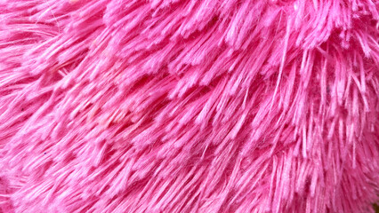 Fototapeta premium Bright pink fluffy faux fur texture with diagonal shaggy pile