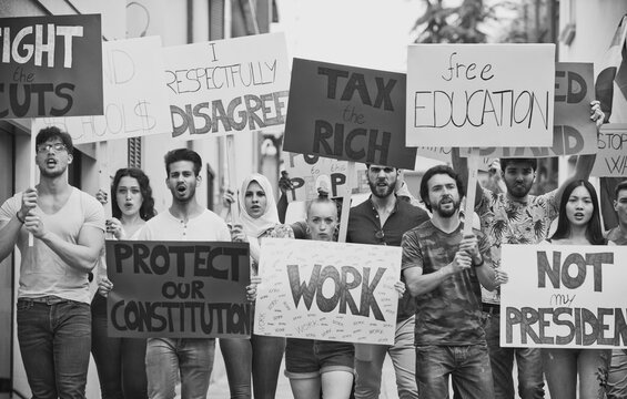 Public demonstration on the street against social problems and human rights. Group of multiethnic people making public protest