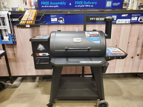Pittsburgh, Pennsylvania, U.S.A - Jul 17, 2026 - Pit Boss 850 DX pellet grill displayed in-store with hopper, control panel, chimney, and promotional assembly signage.