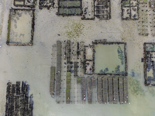 Aerial drone view of underwater oyster farms in Cancale, Brittany, exposed during low tide, raditional sustainable aquaculture and production of premium French oysters, France © barmalini
