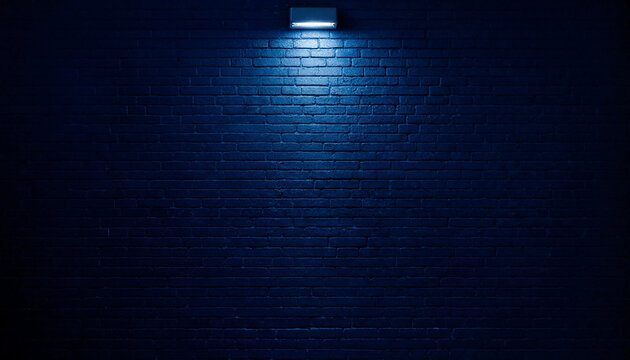 Dark blue brick wall background texture illuminated by a single modern wall sconce light in center position