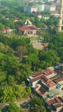 Vertical aerial view of mosque complex within green Yogyakarta neighborhood