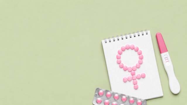 Pregnancy test with pink pills and female symbol for fertility reproductive health treatment and womens family planning.