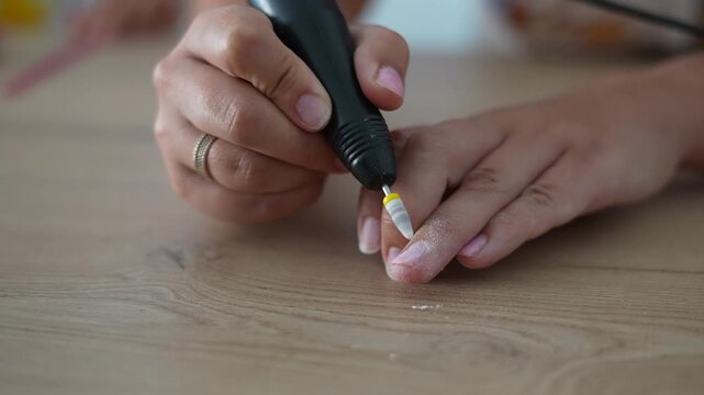Electric Nail Drill Filing Fingernail During Manicure