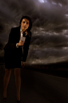 Full length of news reporter in storm 