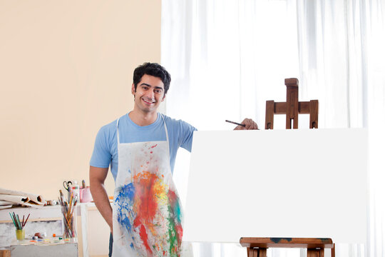 Handsome young man in painting studio 
