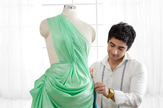 Male tailor working on dressmaker's form 