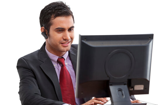 Businessman using computer while on call 