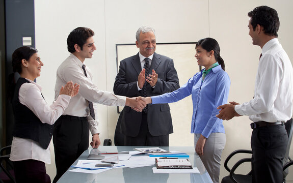 Executives applauding on business agreement 