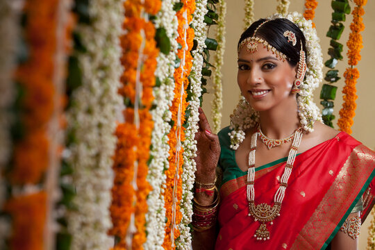 Selective focus of bride standing by garlands 