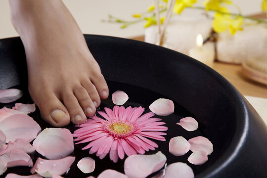 Close-up of a woman's feet and a bowl 