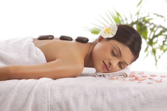 Beautiful young woman getting lastone treatment 