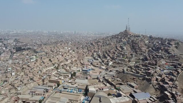 Panoramic aerial perspective of the vast shanty town on cerro la milla in san martin de porres