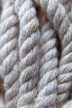 Close-Up Cotton Rope Texture: Twisted Natural Cord Fibers Macro Detail for Rustic and Nautical Design