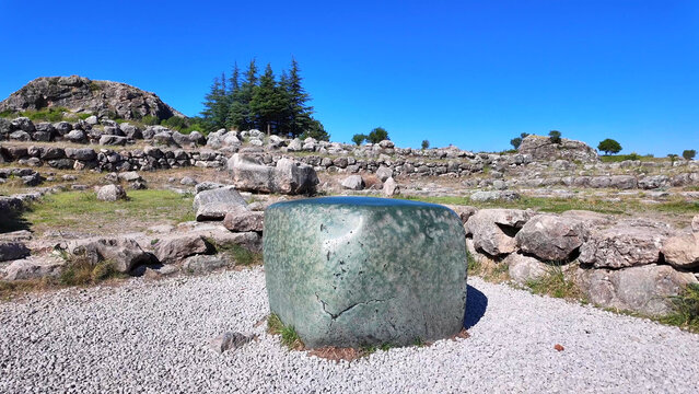 The famous smooth green nephrite stone block stands amid the ancient ruins of the Great Temple at Hattusa, Turkey.

