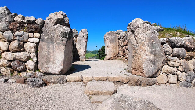 Massive cyclopean megaliths form the imposing structural gateway frames at the ancient Sphinx Gate fortification complex in Hattusa, Turkey.