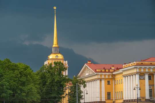 Panoramic Admiralty building facade and golden spire under stormy sky with copy space