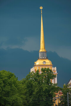 Golden Admiralty spire under dramatic stormy sky with copy space