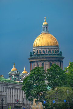 Golden dome of Saint Isaacs Cathedral under stormy sky with copy space