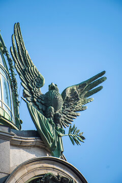 Majestic bronze eagle statue on Singer House under blue sky with copy space