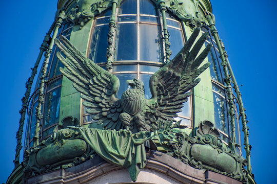 Bronze eagle sculpture on iconic Singer House tower with blue sky copy space