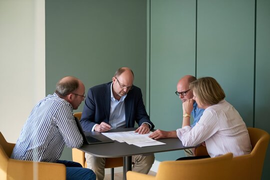 Senior leadership team discussing budget cuts and cost reduction strategy during difficult corporate financial planning meeting