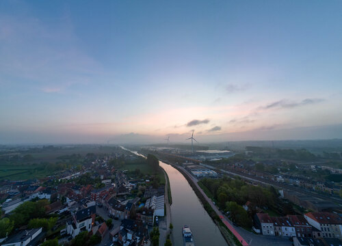 Lot, Beersel, Vlaams-Brabant, 22nd of April, 2025, A peaceful aerial landscape beautifully showcasing a winding river amidst lush greenery under a tranquil twilight sky