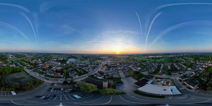 Halle, Vlaams Brabant, Belgium, 27th of April, 2025, This breathtaking aerial view shows a charming town at sunset, highlighting vibrant colors and serene landscapes