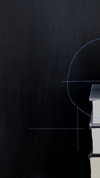 Apple on top of a pile of books and mathematical equations and graphs