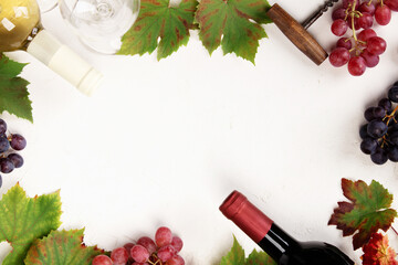 Naklejka premium Wine Bottles and Grapes on White Background with Copy Space