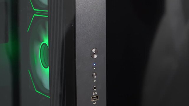 Finger pressing power button to start desktop computer