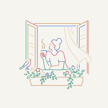 Woman drinking hot coffee by the window
