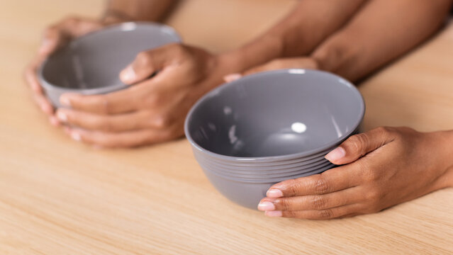 Focused Unrecognizable Hands Holding Gray Bowls Together In Kitchen Setting, Preparing Ingredients For Cooking And Meal Preparation, Showing Cooperation And Culinary Activity.
