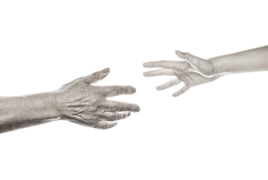 Old woman and a kid holding hands together, help. Care and support concept, senior woman and young woman holding hands. Black and white