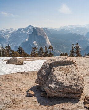Vertical view of majestic Half Dome from Sentinel Dome summit with granite rocks