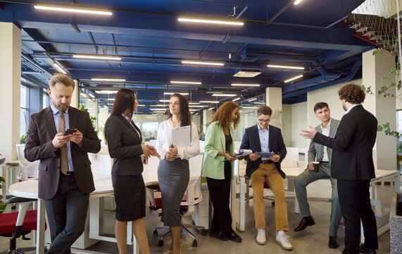 Professionals teamwork meeting collaboration in modern office. Colleagues and coworkers in networking and discussion plan tasks in a workspace. Teamwork and collaboration for diverse group.