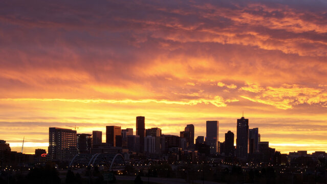 Downtown Denver Skyline beneath Fiery Sunrise Sky