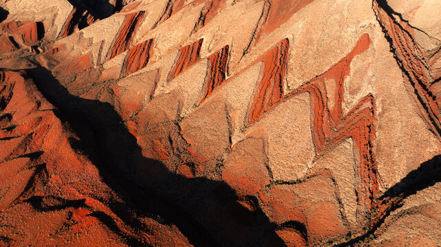 Aerial view of the distinctive zigzag geological rock formations in the desert landscape near Moab, Utah, United States.