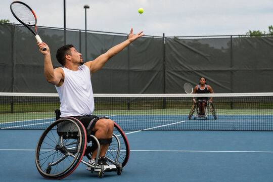 Wheelchair Tennis Player Serving on Outdoor Court