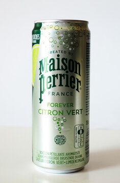 An aluminum can of Maison Perrier Forever Citron Vert sparkling lime water on a white background with copy space.