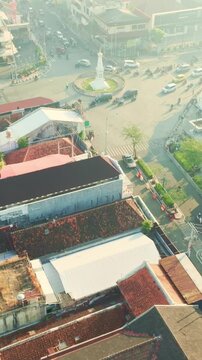 Elevated city view toward Tugu Yogyakarta and surrounding rooftops