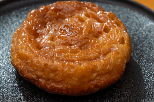 Kouign-amann legendary Breton confection from Douarnenez,  Saint-Malo, Brittany with butter, sugar, puff dough, crispy caramelized layers, authentic French pastry with centuries-old tradition