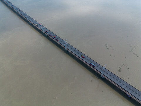 Aerial view of Jamuna Bridge spanning the Jamuna River with vehicles traveling across the multi-lane highway in Tangail District, Dhaka Division, Bangladesh.