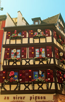 Colmar, France. Au Vieux Pignon, a half-timbered house known for its Alsatian architecture and is decorated with flowers and hearts.  The architecture was the inspiration for Beauty and the Beast
