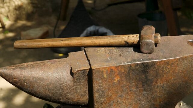 A heavy metalworking tool with a hammer on top, ideal for use in industrial or mechanical designs