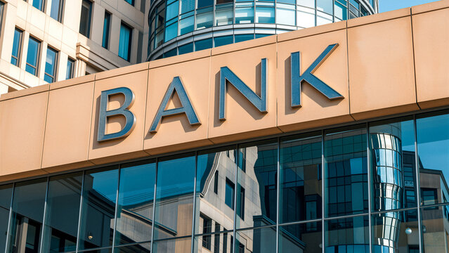 Modern bank building facade with reflective windows and signage.